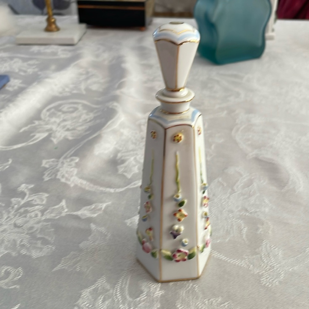Vintage perfume bottle by Irice marked on bottom. 3-d floral design.